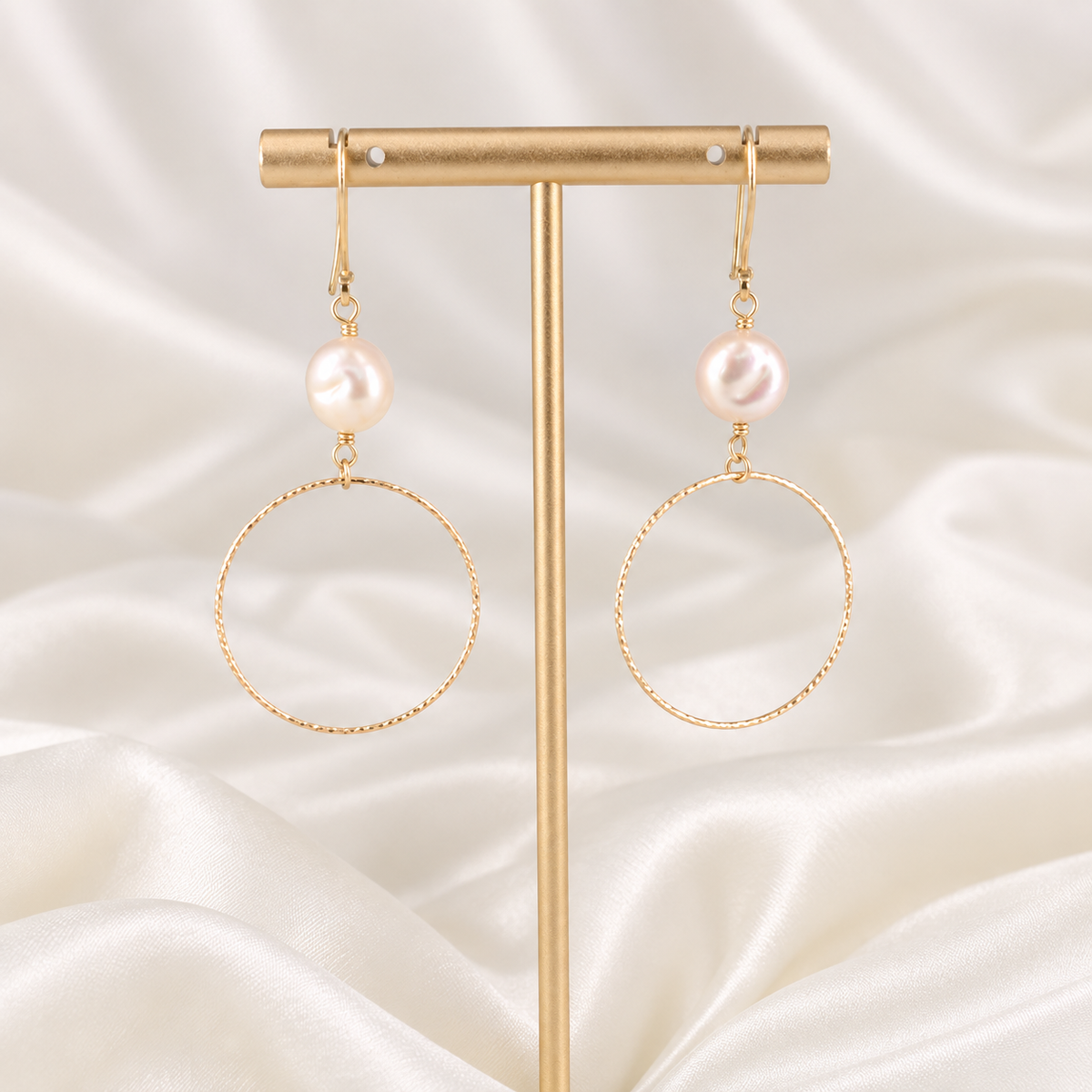 Front view of handmade Isolde earrings with softly oval pearls and textured gold-filled hoops