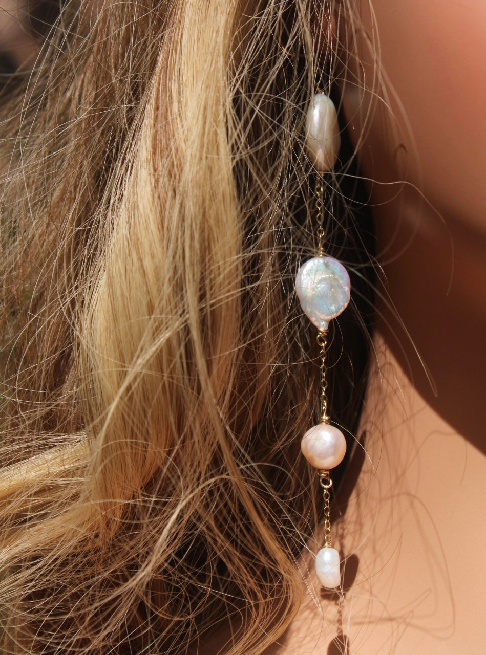 Long freshwater pearl shoulder-duster earring worn to show approximately five-inch length