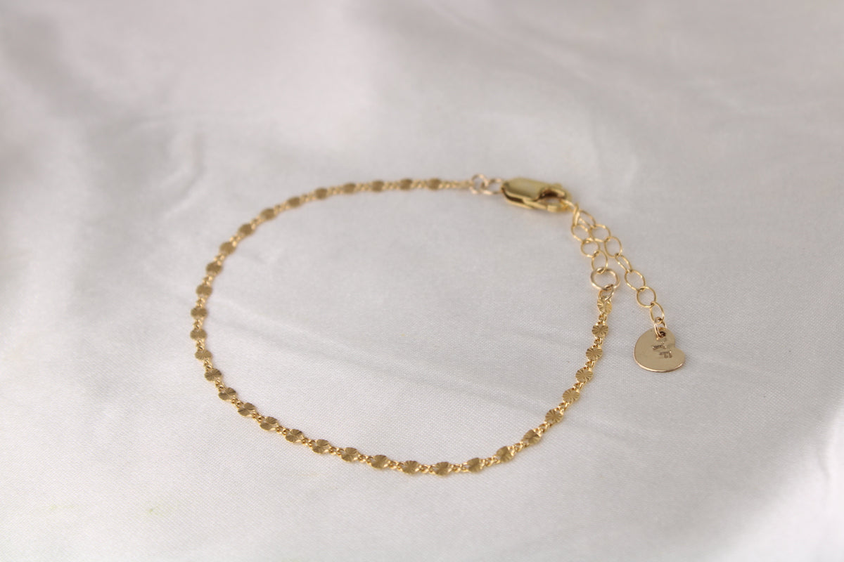 Gold disc-chain bracelet with lobster clasp and TF heart tag