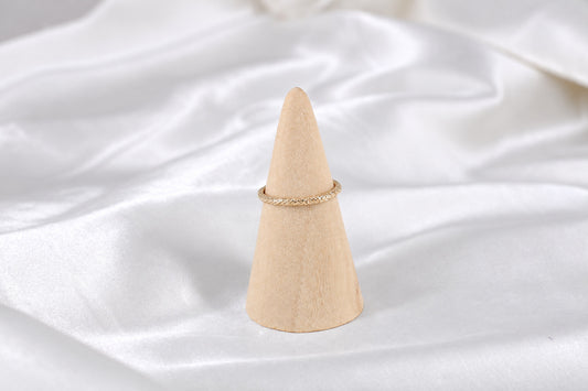 Lena gold-filled sparkle band on a wooden ring cone