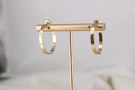 Lightly hammered gold-filled ribbon hoops on a display stand
