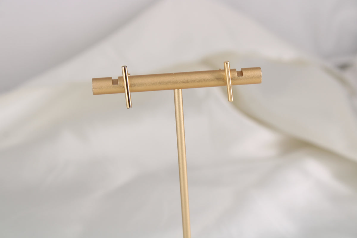 Minimal T-Bar Studs in 14K gold-filled on jewelry stand